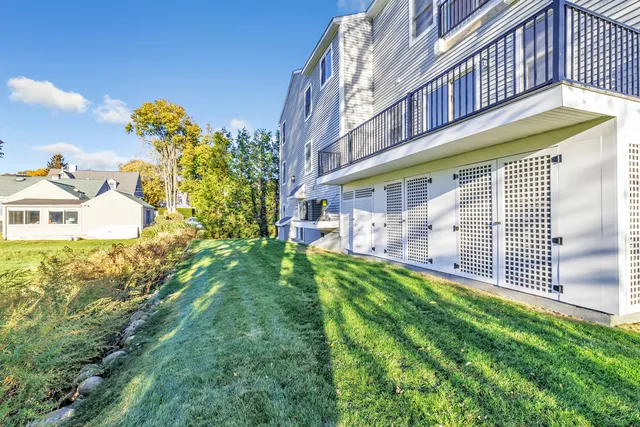 a view of a house with a yard and a garden