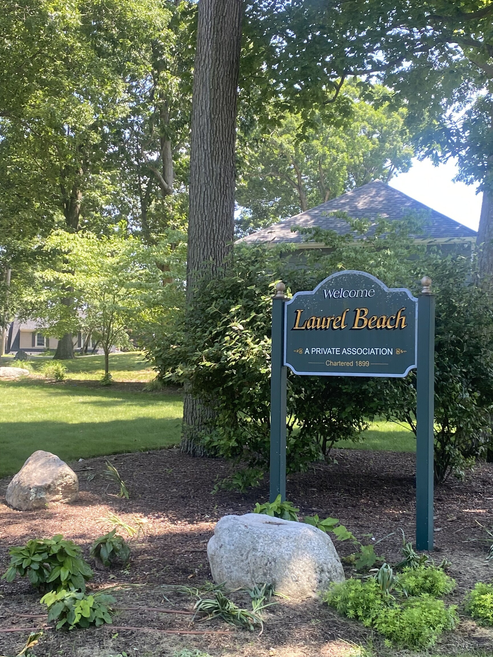 212 Milford Point Road Milford, CT 06460 - Photo 33 of 38 a sign that is sitting in front of a tree