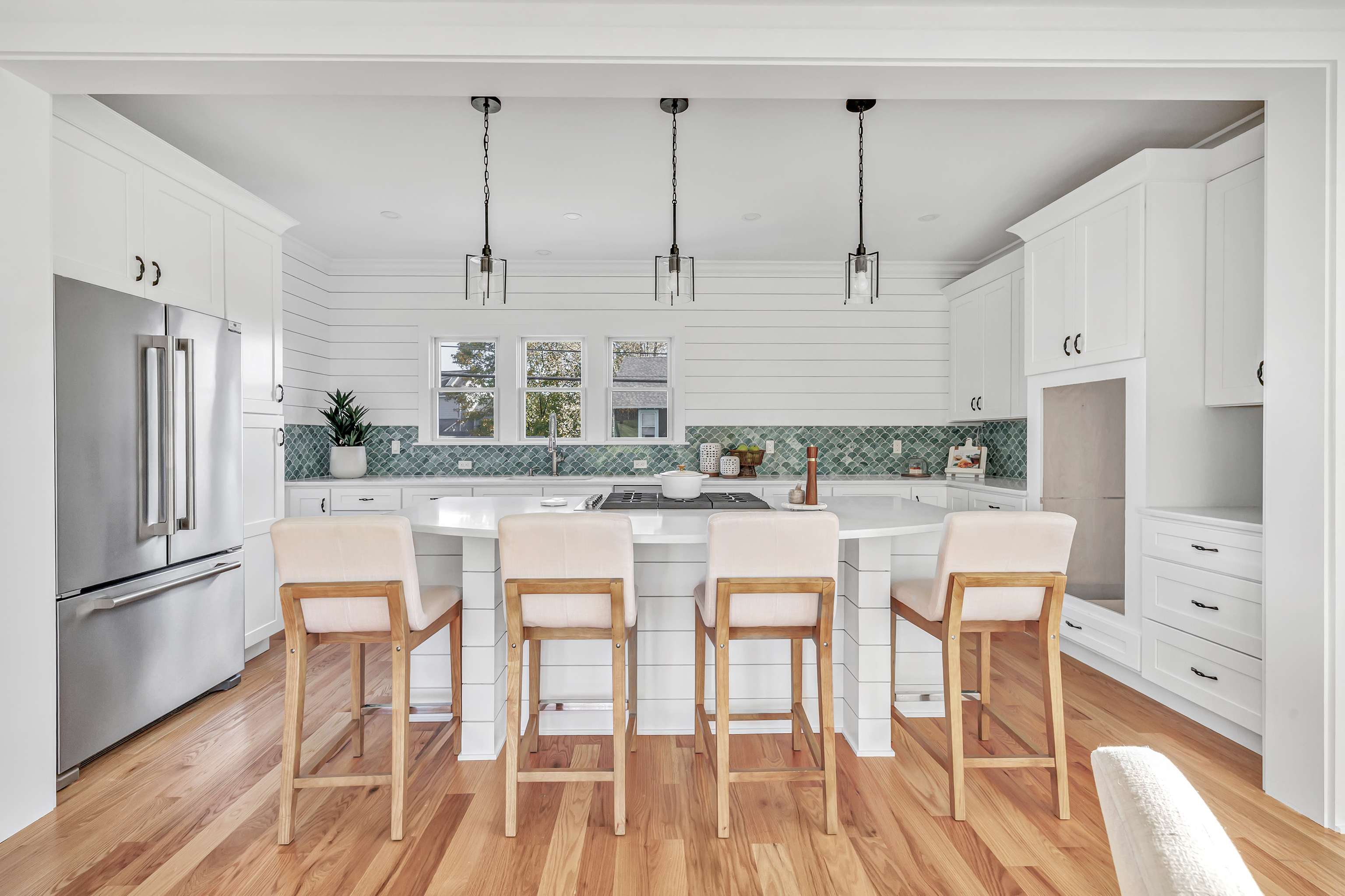 212 Milford Point Road Milford, CT 06460 - Photo 7 of 38 a kitchen with stainless steel appliances granite countertop a refrigerator a stove and white cabinets with wooden floor