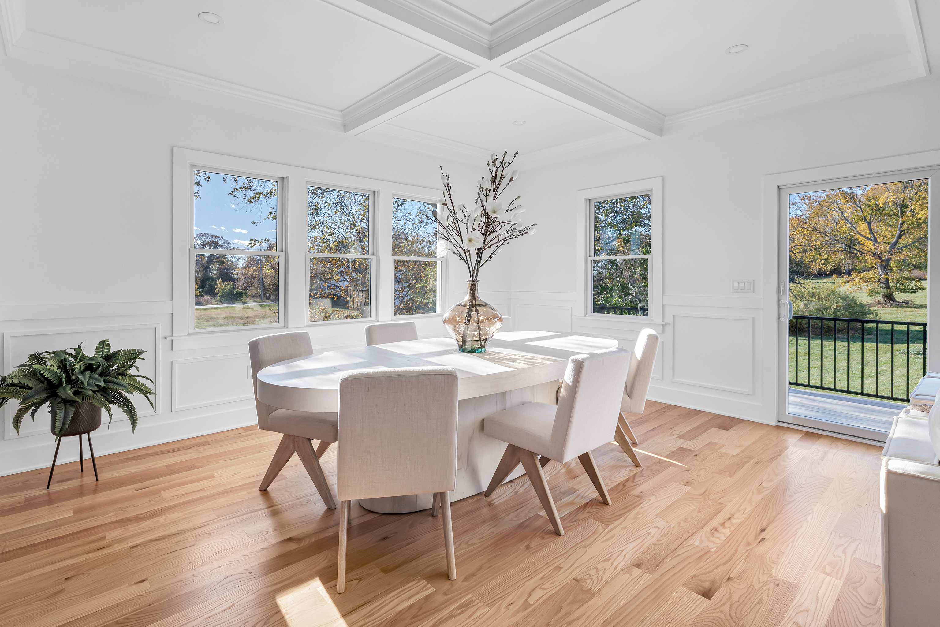212 Milford Point Road Milford, CT 06460 - Photo 10 of 38 a dining room with wooden floor a glass table and chairs