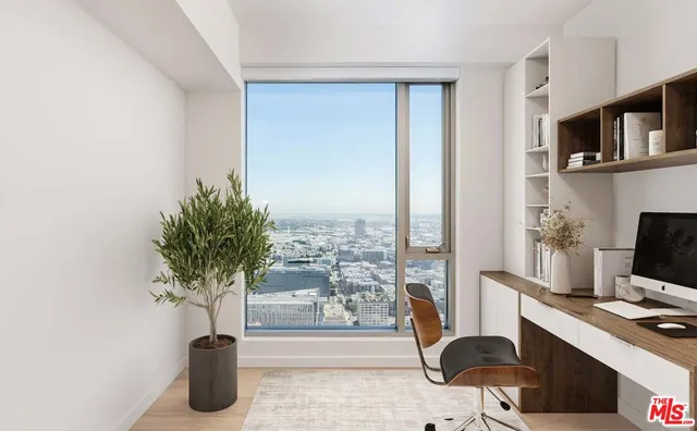 a view of a workspace with furniture and a potted plant