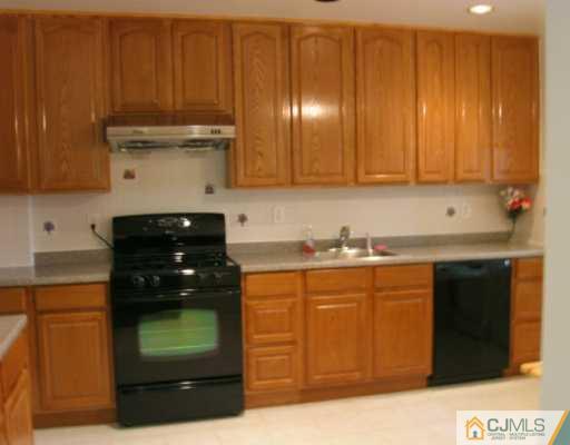 5 Eagle Road Edison, NJ 08820 - Photo 4 of 6 a kitchen with stainless steel appliances granite countertop a refrigerator and a stove
