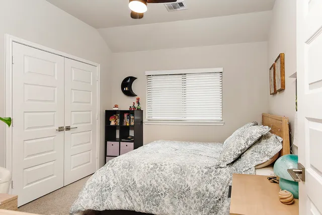 a bedroom with a bed and a cabinets