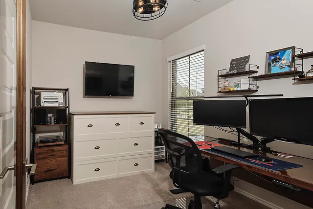 a livingroom with a flat screen tv and a window