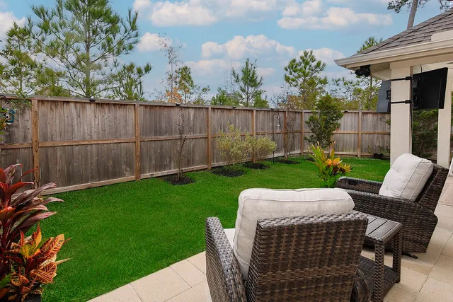 a view of backyard with seating space and trees