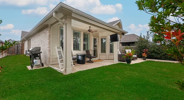 a view of a house with backyard porch and sitting area