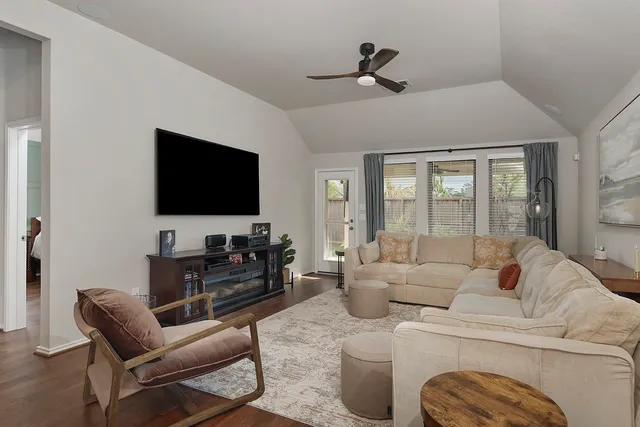 a living room with furniture and a flat screen tv