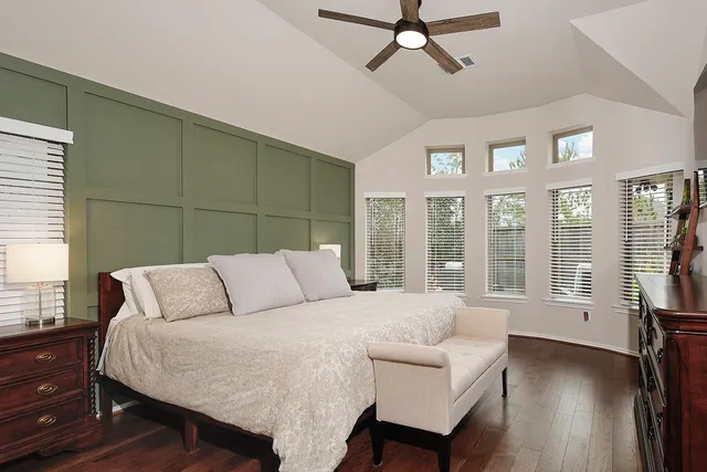 a bedroom with a large bed and a large window