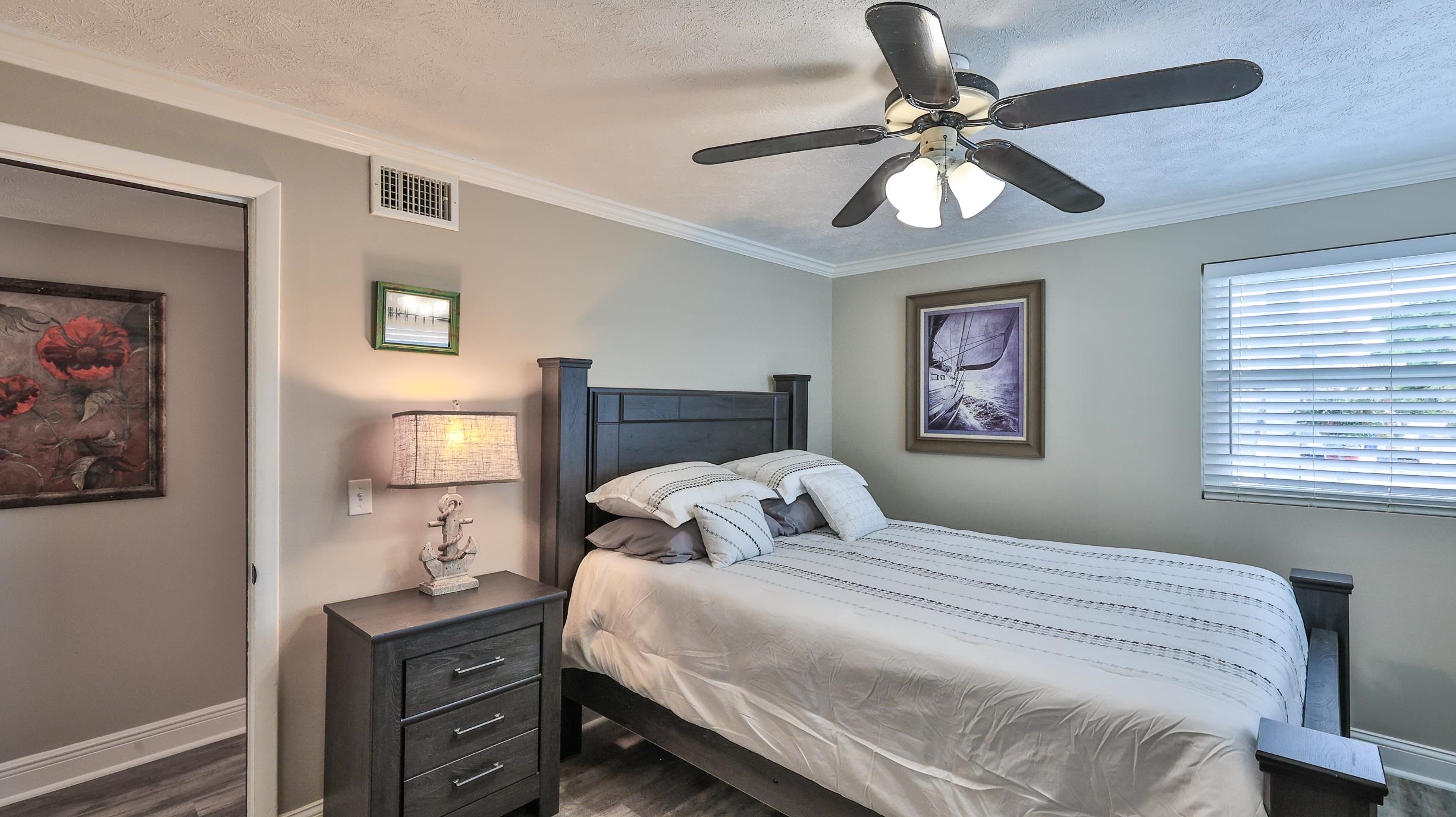 49 Zamora Street St. Augustine, FL 32084 - Photo 17 of 64 a bedroom with a bed and a chandelier