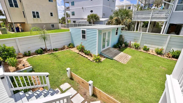 a view of a roof deck with table and chairs under an umbrella
