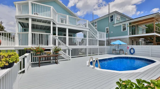 a view of balcony with wooden floor and seating space
