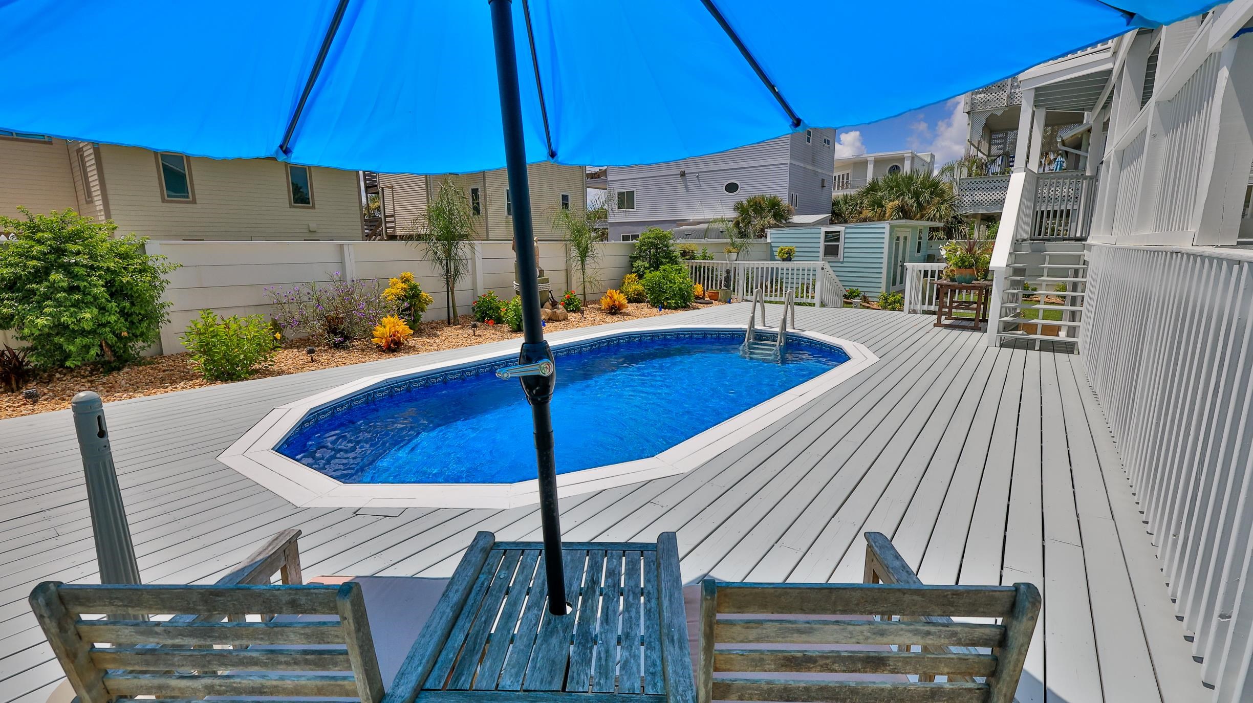 49 Zamora Street St. Augustine, FL 32084 - Photo 26 of 64 a view of a roof deck with table and chairs under an umbrella