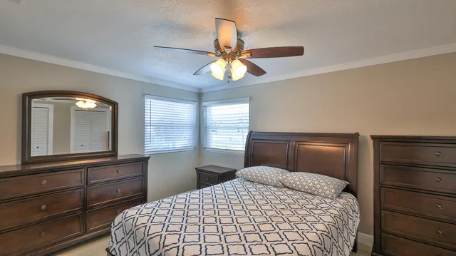 a bedroom with a bed and a television