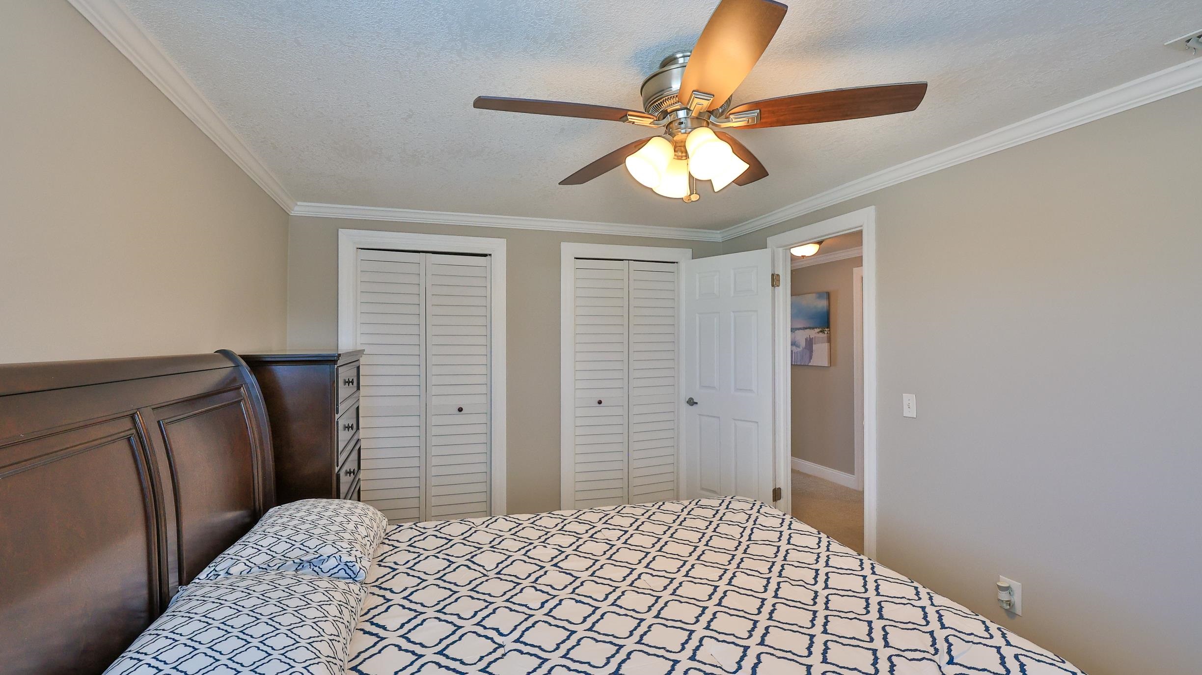 49 Zamora Street St. Augustine, FL 32084 - Photo 33 of 64 a bedroom with a bed and a chandelier