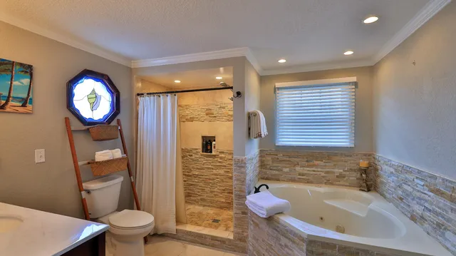 a living room with furniture and a view of kitchen