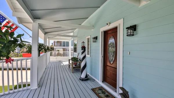 a view of a hallway with entryway wooden floor and front door
