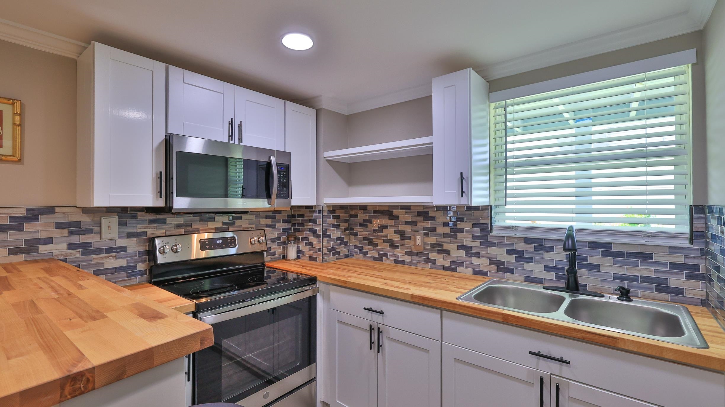 49 Zamora Street St. Augustine, FL 32084 - Photo 45 of 64 a kitchen that has a sink and a stove top oven