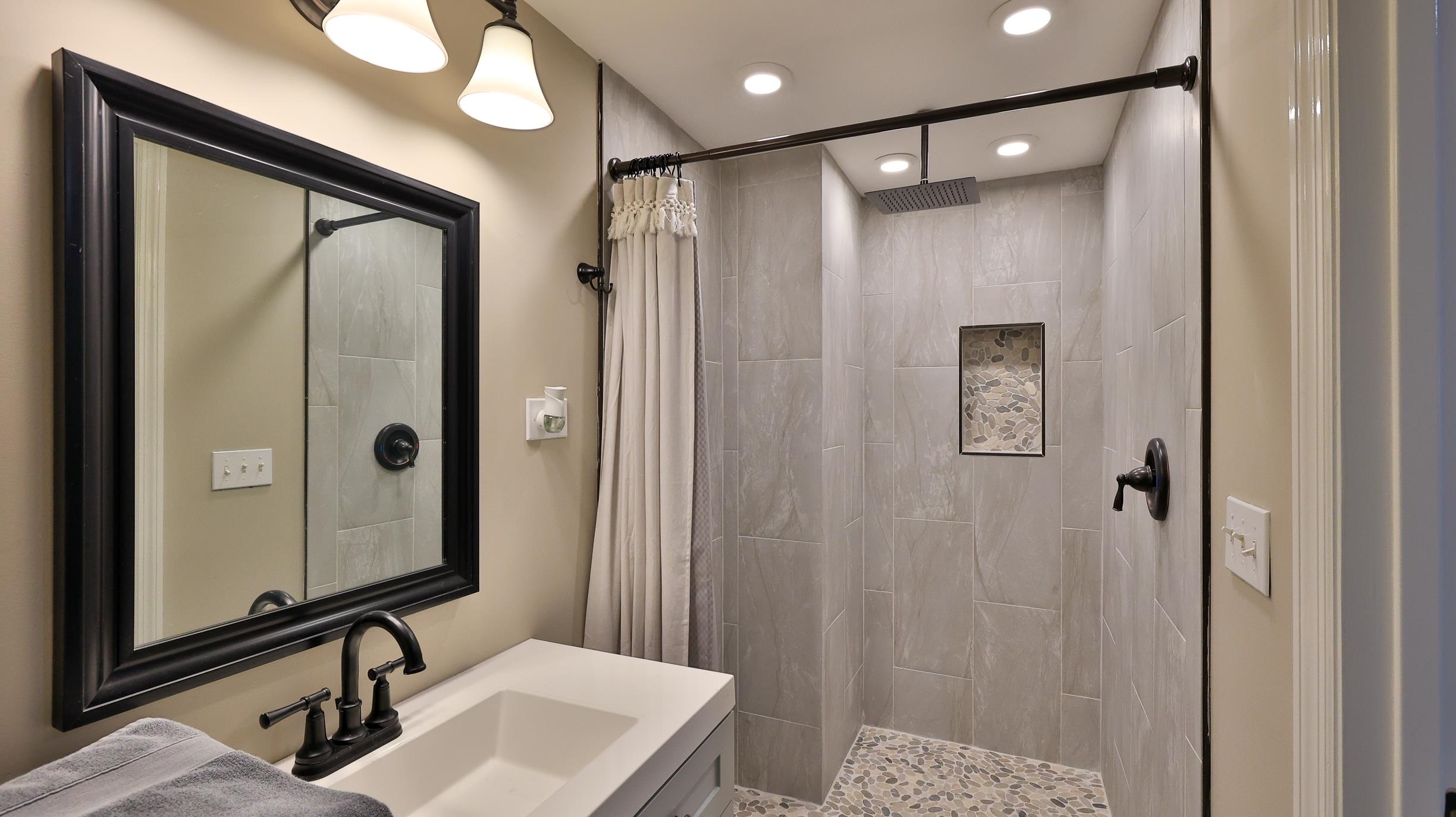 49 Zamora Street St. Augustine, FL 32084 - Photo 48 of 64 a bathroom with a mirror a sink and a mirror