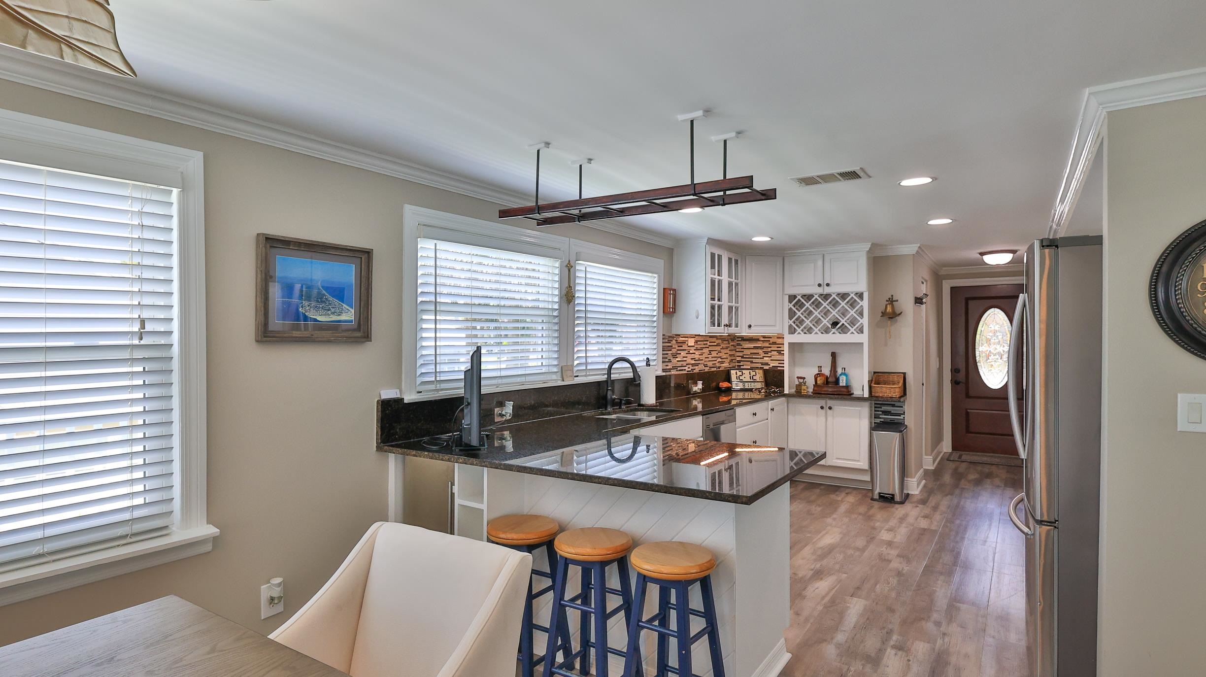 49 Zamora Street St. Augustine, FL 32084 - Photo 9 of 64 a kitchen with a table chairs stove and wooden floor