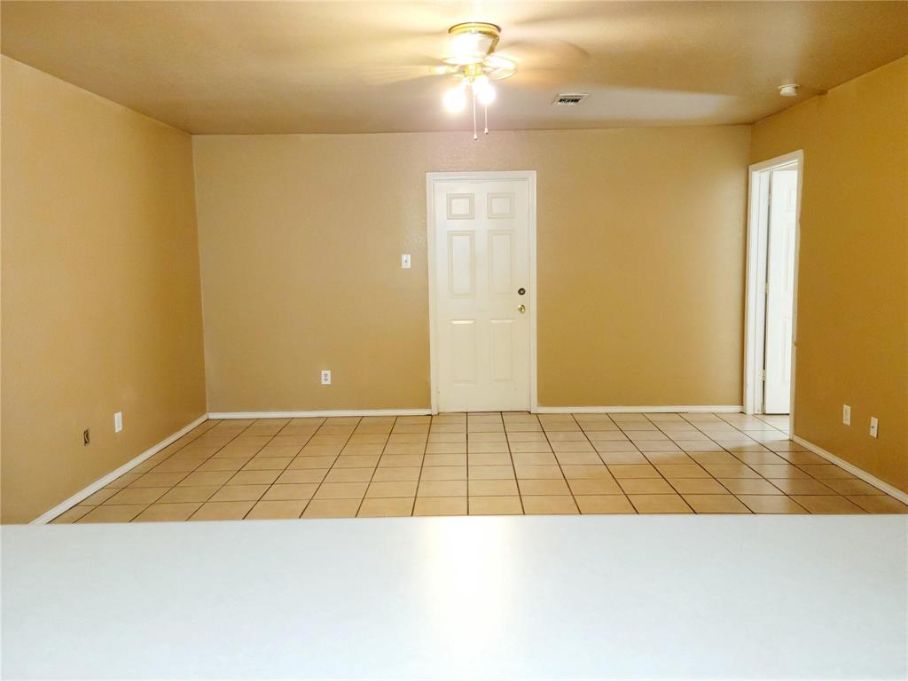 2782 Batey Road, Unit 2780 Collinsville, TX 76233 - Photo 6 of 9 Spacious interior room featuring light-toned tile flooring, neutral wall paint, and white trim and view from kitchen