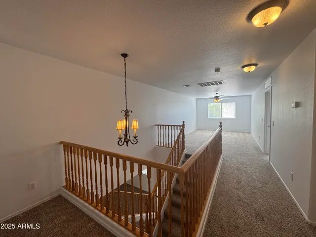 a view of a hallway view with staircase