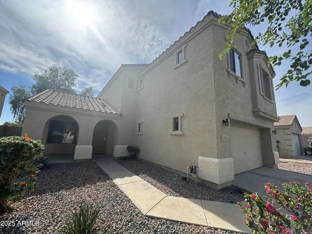 a front view of a house with plants