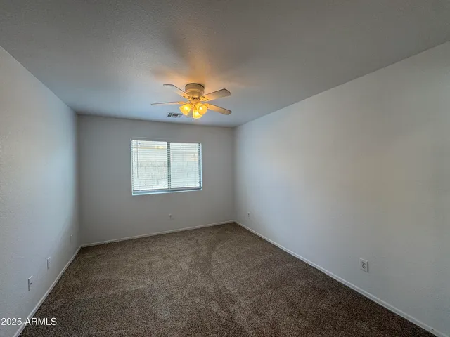 an empty room with a window and fire pit