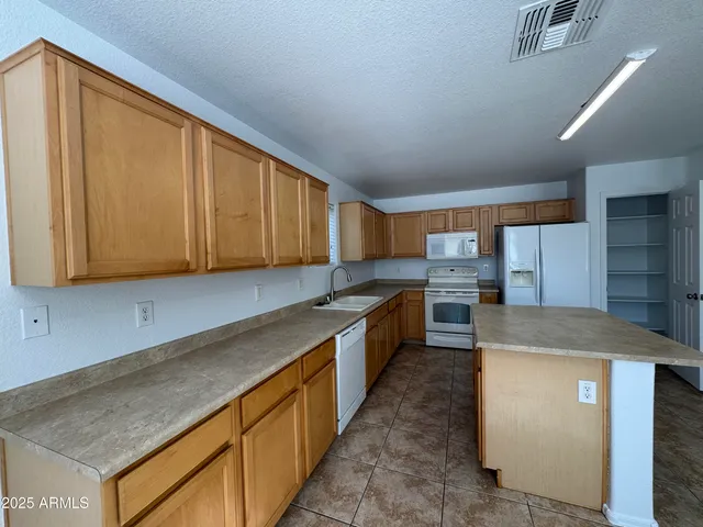 a kitchen with stainless steel appliances granite countertop a sink counter space cabinets and a sink