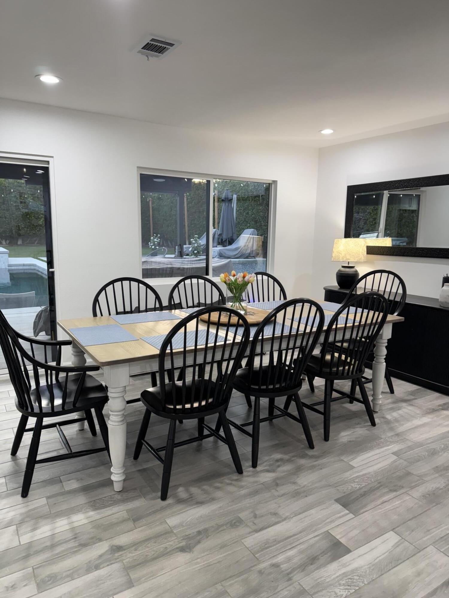 37081 Palmdale Road Rancho Mirage, CA 92270 - Photo 13 of 46 a view of a dining room with furniture and wooden floor