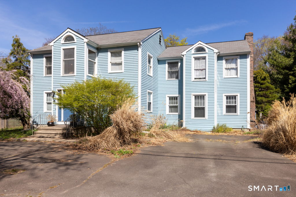 49 River Street Old Saybrook, CT 06475 - Photo 1 of 28 a front view of a house with a yard