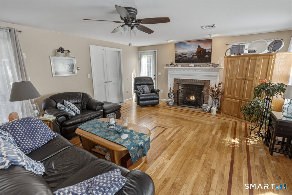 49 River Street Old Saybrook, CT 06475 - Photo 13 of 28 a living room with furniture and a fireplace