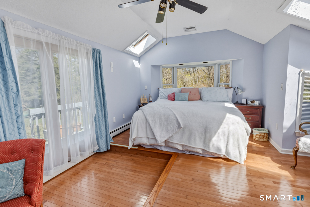 49 River Street Old Saybrook, CT 06475 - Photo 15 of 28 a bedroom with a bed and a window