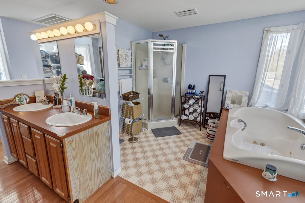 49 River Street Old Saybrook, CT 06475 - Photo 16 of 28 a bathroom with a tub sink and mirror
