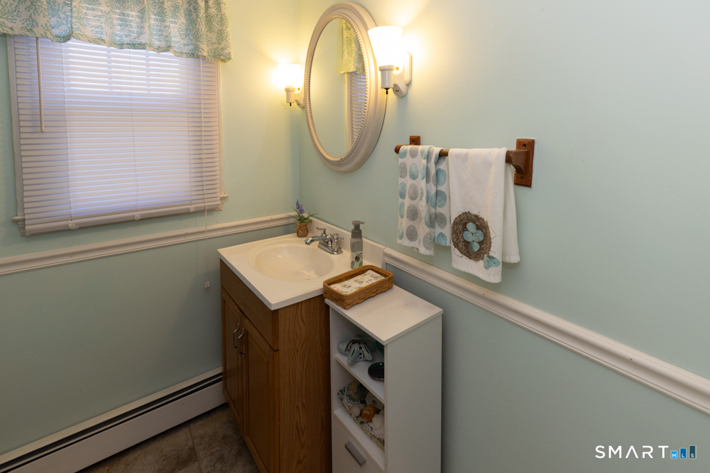 49 River Street Old Saybrook, CT 06475 - Photo 21 of 28 a bathroom with a sink and a mirror