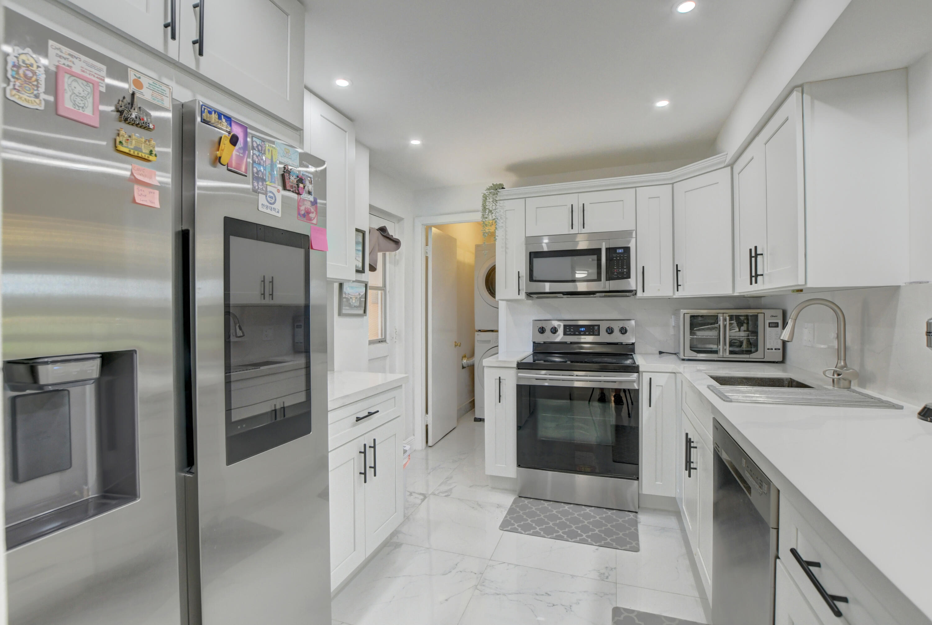 a kitchen with stainless steel appliances cabinets a refrigerator and a stove