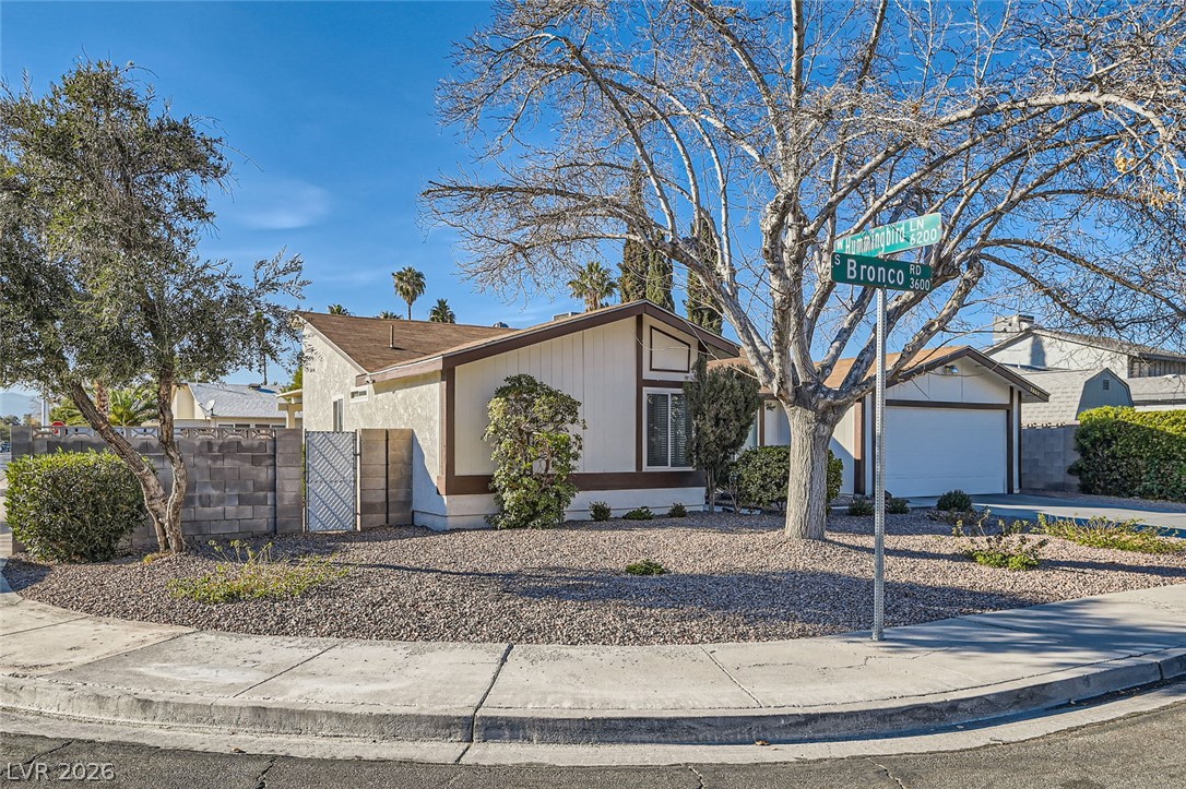3665 Bronco Road Las Vegas, NV 89103 - Photo 2 of 28 A well-maintained residential corner property with mature trees and a neatly graveled yard.