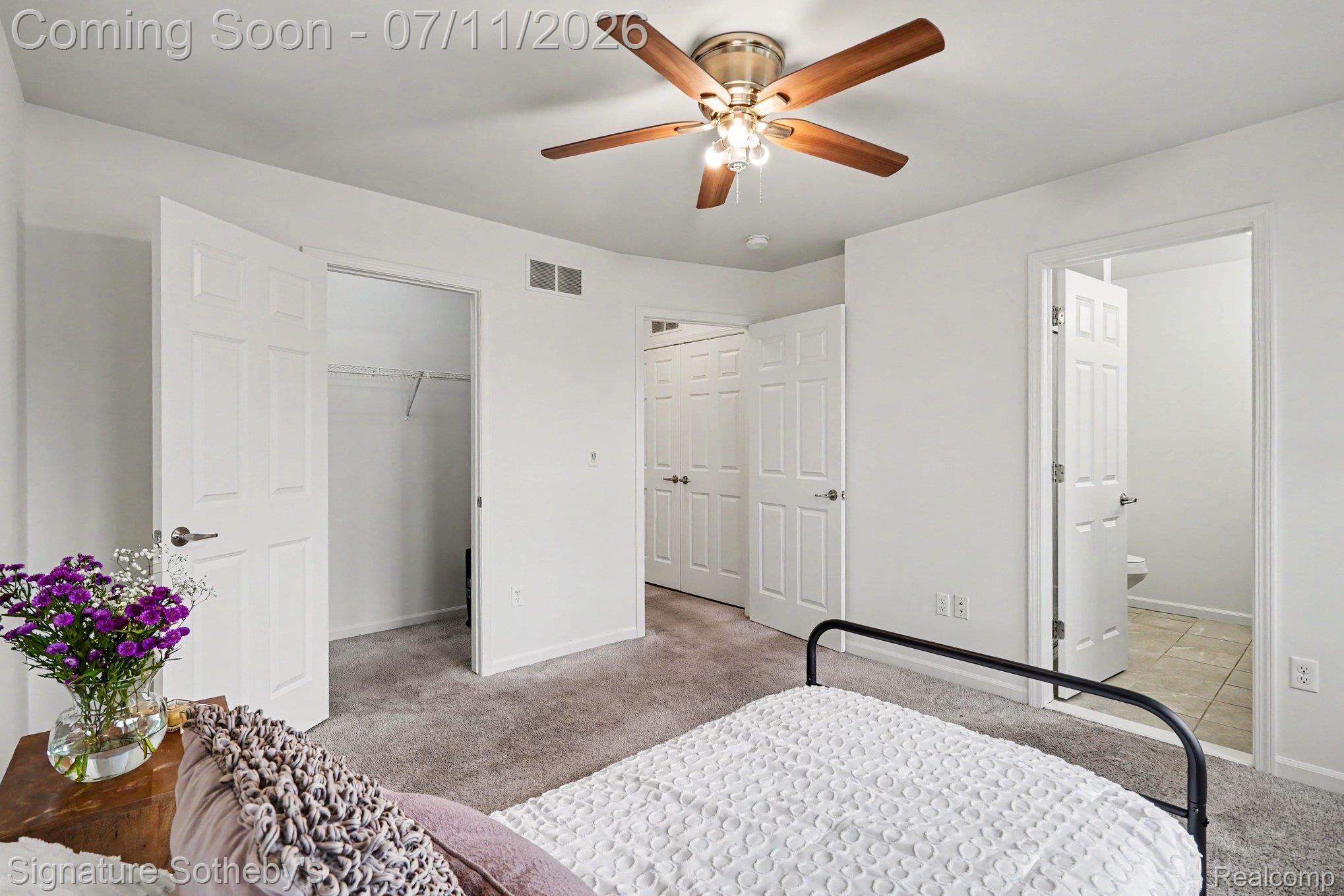 2500 Normandy Road, Unit 40 Royal Oak, MI 48073 - Photo 18 of 26 Bedroom featuring neutral carpeting, a ceiling fan with wood-finish blades, and white trim