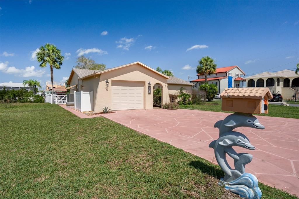 4315 Flexer Drive Hernando Beach, FL 34607 - Photo 12 of 48 a front view of a house with garden