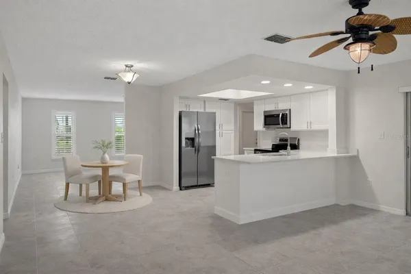 a living room with kitchen island furniture and a chandelier