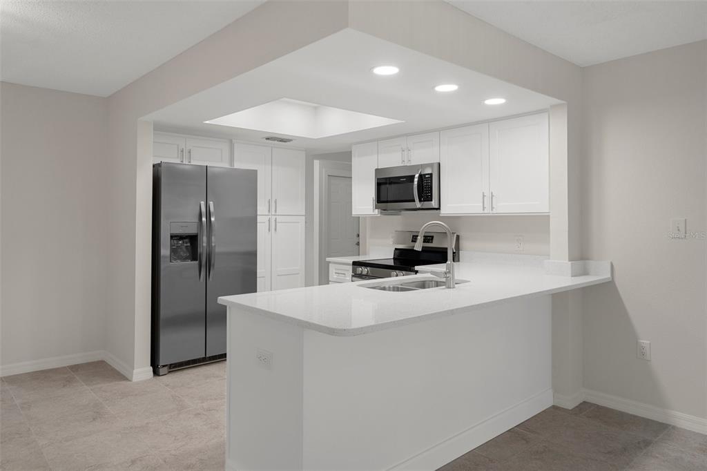 4315 Flexer Drive Hernando Beach, FL 34607 - Photo 20 of 48 a kitchen with kitchen island a sink stainless steel appliances and cabinets