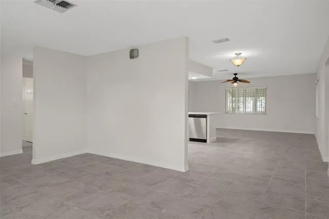 a view of kitchen with stainless steel appliances refrigerator stove microwave and cabinets
