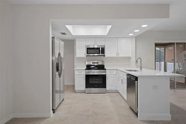 a room with a sink and cabinets