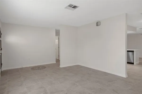 a kitchen with kitchen island a refrigerator and a sink