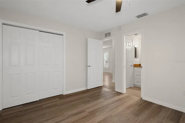 a bathroom with a granite countertop sink a toilet and a bathtub