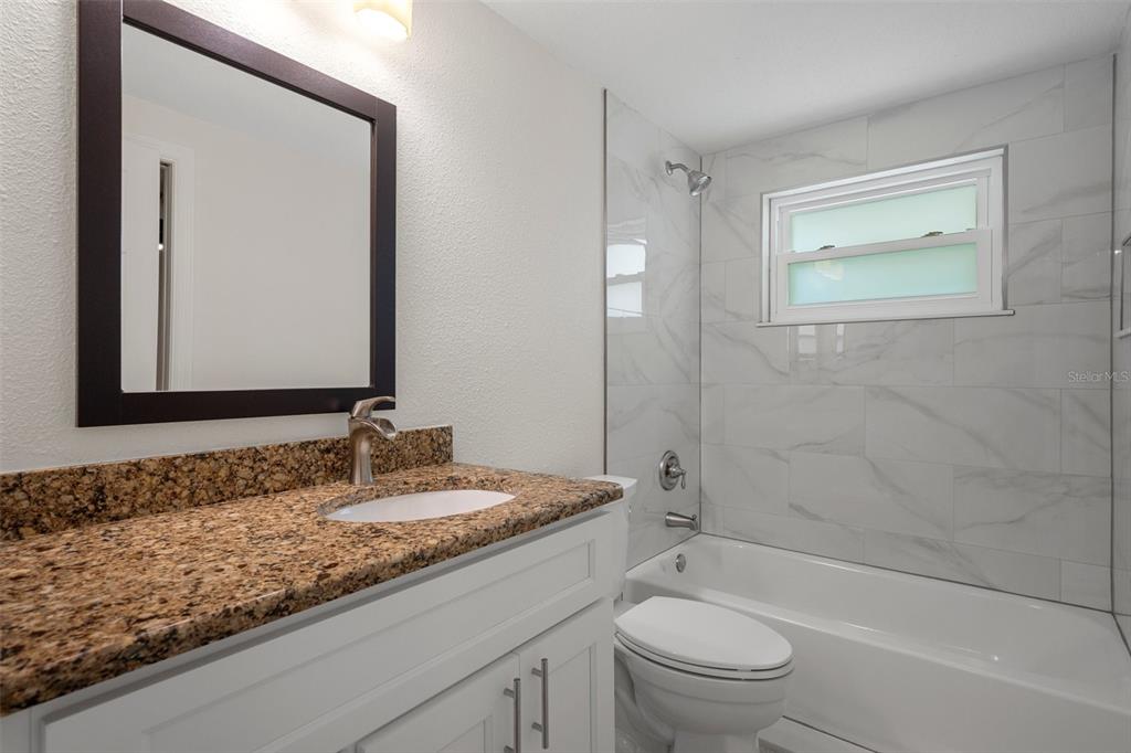 4315 Flexer Drive Hernando Beach, FL 34607 - Photo 40 of 48 a bathroom with a granite countertop sink toilet and shower