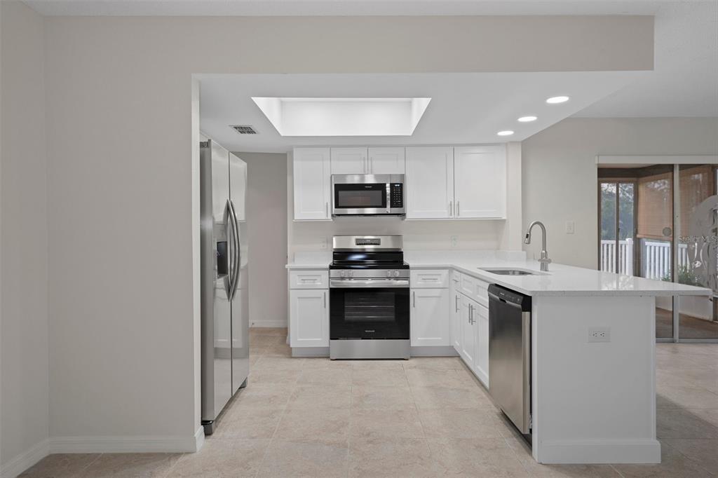 4315 Flexer Drive Hernando Beach, FL 34607 - Photo 4 of 48 a kitchen with a stove top oven and refrigerator