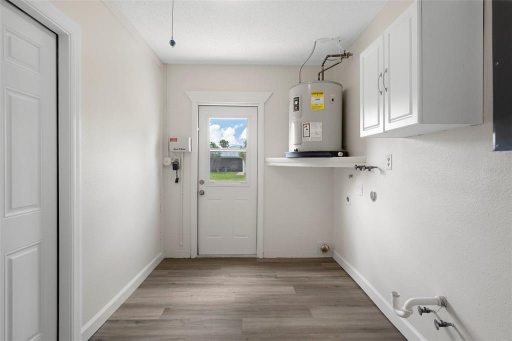 4315 Flexer Drive Hernando Beach, FL 34607 - Photo 42 of 48 an entryway to room with wooden floor and cabinet