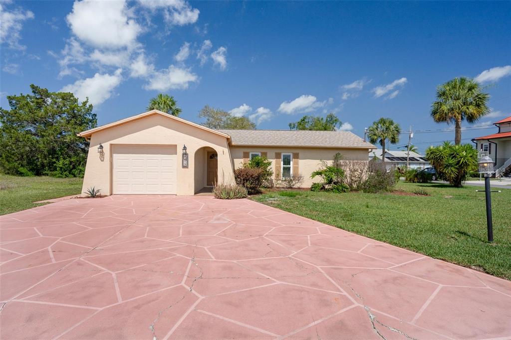 4315 Flexer Drive Hernando Beach, FL 34607 - Photo 47 of 48 a front view of a house with a yard and garage