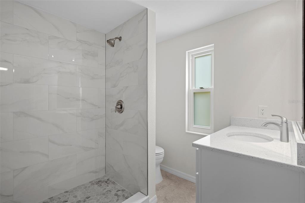 4315 Flexer Drive Hernando Beach, FL 34607 - Photo 6 of 48 a bathroom with a sink a toilet and shower