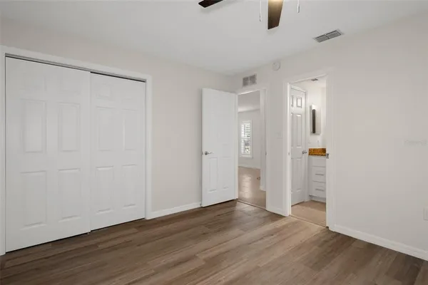 a view of an empty room with wooden floor